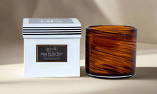 Load image into Gallery viewer, Hand blown brown swirl glass candle scent as "Musk We Do This?"