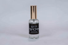Load image into Gallery viewer, A small clear glass spray bottle with a metallic gold cap and a black label reading BOUGIE Napa, Tide & Timber centered on a black label.