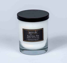 Load image into Gallery viewer, Candle in a glass jar with a black lid and label on a white background
