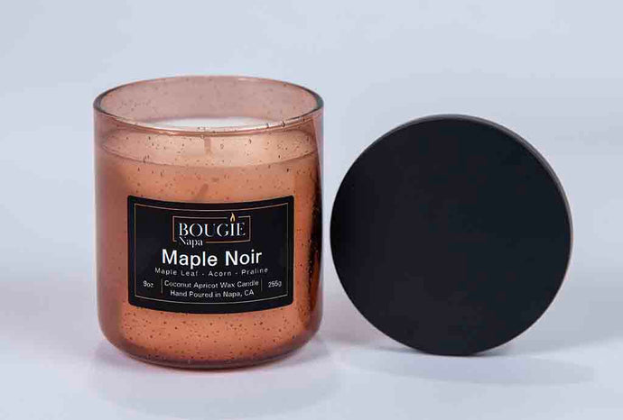 Candle with a black lid on a white background