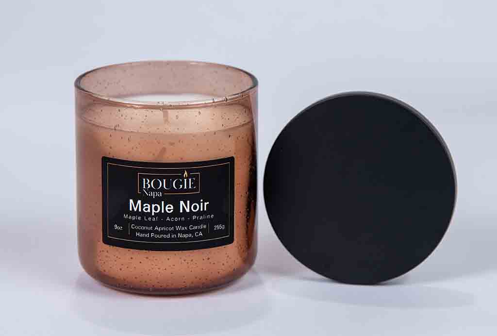 Candle with a black lid on a white background