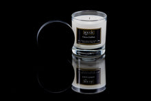 Load image into Gallery viewer, A white candle in a clear glass jar with a black metal lid, labeled 'Napa Valley', on a reflective black surface.
